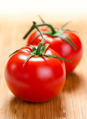 Two tomatoes on the board.