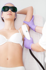 Young woman receiving epilation laser treatment