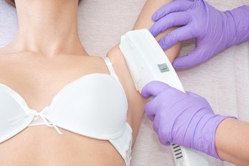 Young woman receiving epilation laser treatment