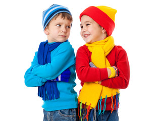 Two emotional kids in winter clothes