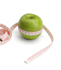 A green apple and a measurement tape