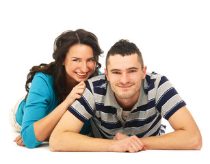 A young couple lying on the floor , isolated on white background