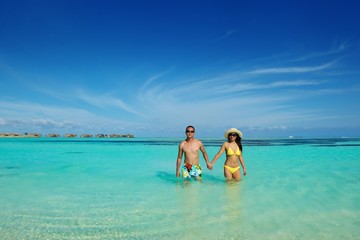 asian couple enjoying summer on beach