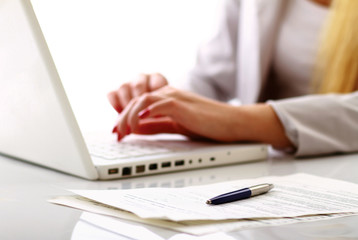 Close-up of businesswoman typing documents
