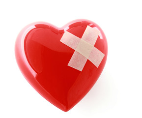 A red heart with adhesive plaster