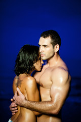 Fototapeta na wymiar Young couple embracing on tropical beach