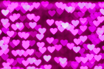 Valentine pink hearts bokeh as background.