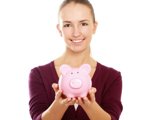 Happy teen holding a piggy bank and dollars