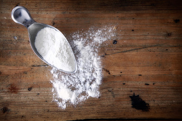 Metal scoop with spilled flour