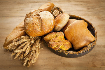 assortment of fresh baked bread on wood table
