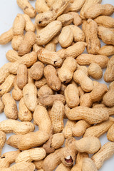 .Dried peanuts in closeup on the white background