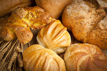 assortment of fresh baked bread on wood table