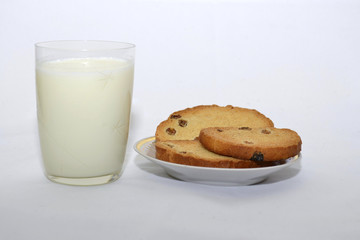 biscuits with raisins and milk on a white background
