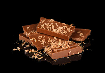 Milk chocolate isolated on black