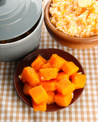 Taste rice porridge with pumpkin in bowl