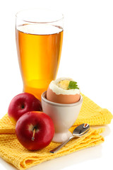 Light breakfast with boiled egg and glass of juice, isolated