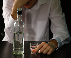 Man with bottle of alcohol,  on black background