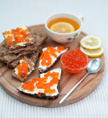 red caviar and tea with lemon for breakfast
