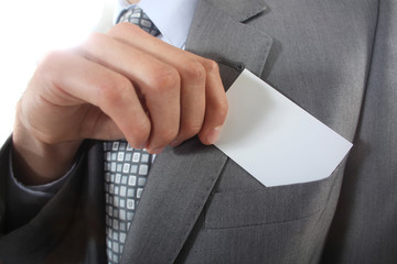 Businessman pulling a business card out of his pocket
