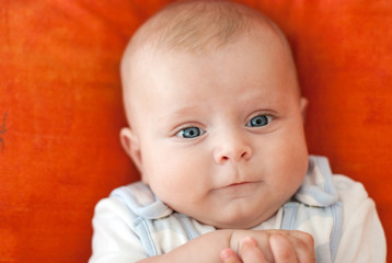 Adorable baby child on orange background