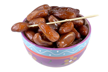 Dish with dried dates on a white background.