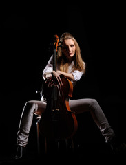 Fototapeta na wymiar attractive girl with cello isolated over black background