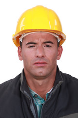 A construction worker with a weird expression.