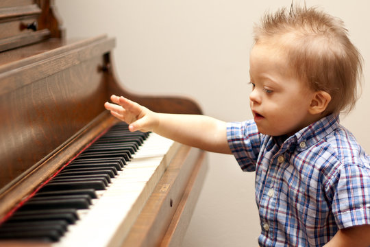 Down Syndrome child playing at piano