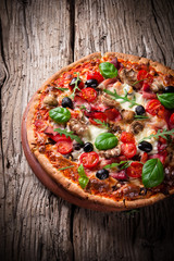 Delicious italian pizza served on wooden table