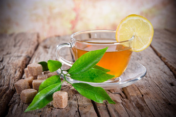 Cup of green tea on wood board