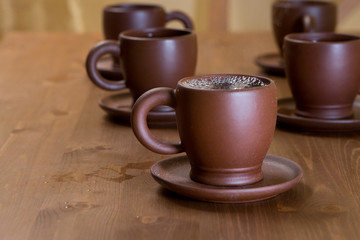 Clay cups on a wooden table