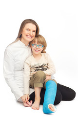 Young mother with her smiling son - portrait on the floor