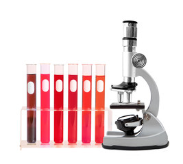 Medical test tubes with blood in holder and microscope on white