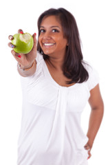 Young indian woman eating an apple