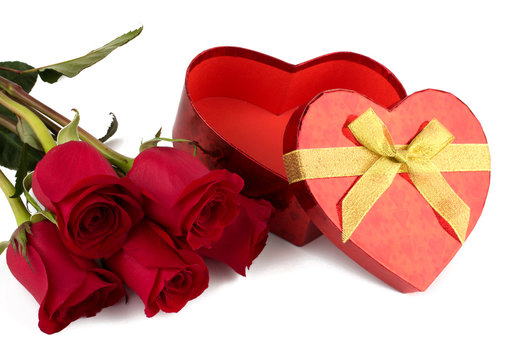 Red heart-shaped  gift box and red roses.