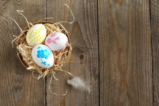 Colorful painted easter eggs in brown paper box