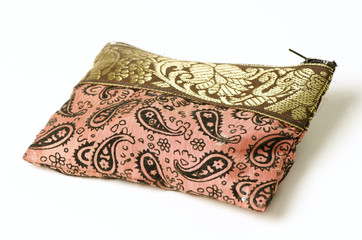 Golden and pink pouch isolated on white