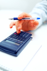 Closeup of a businessman calculating