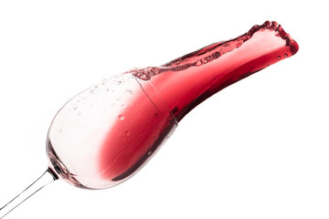 red wine splashing out of a glass, isolated on white