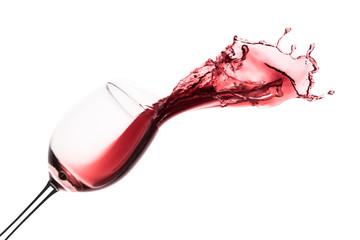 red wine splashing out of a glass, isolated on white