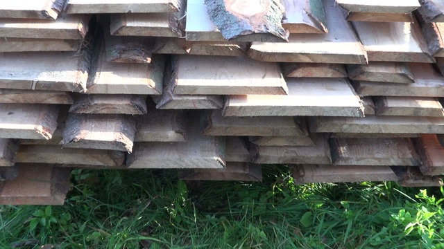 new fir planks on grass in farm