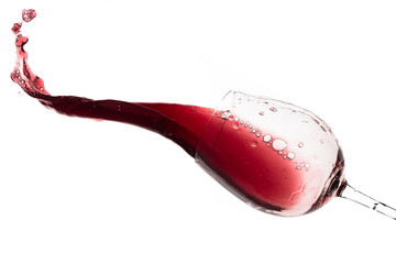 red wine splashing out of a glass, isolated on white