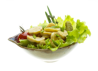 Marinated mushrooms in white saucer isolated on white