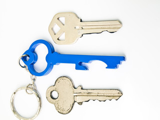 Couple keys and  a blue stainless steel key's keychainisolated o