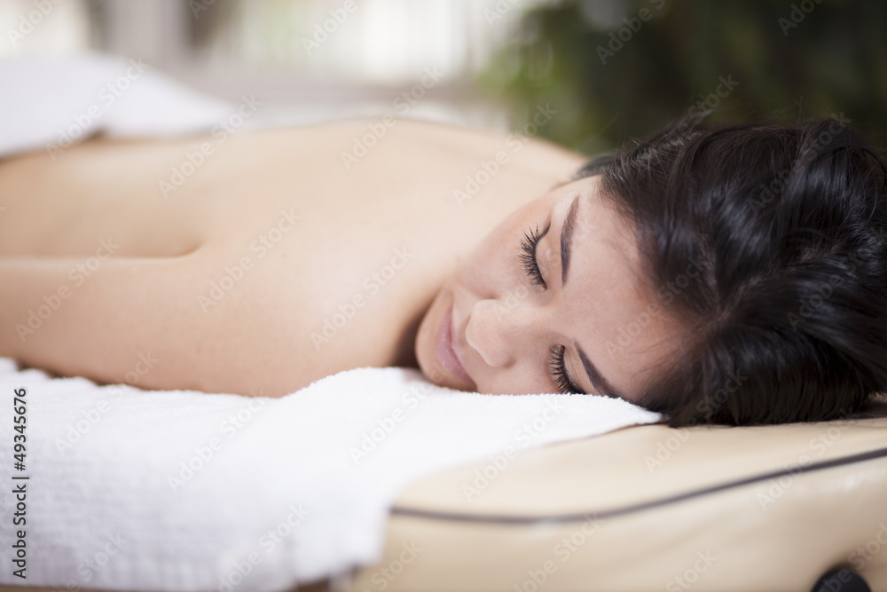 Wall mural Very relaxed young woman at a spa