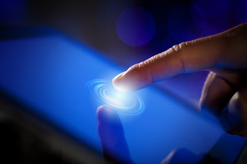 Closeup of finger touching tablet-pc screen