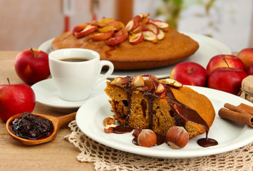 slice of tasty homemade pie with chocolate and apples and cup