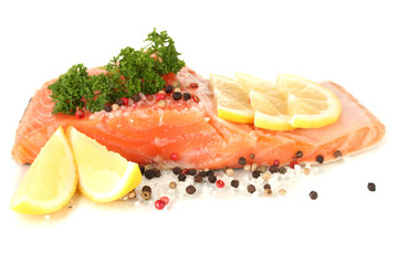Fresh salmon fillet with herbals and lemon slices, isolated