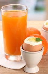 Light breakfast with boiled eggs and glass of juice