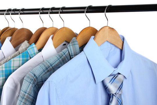 Shirts with ties on wooden hangers isolated on white
